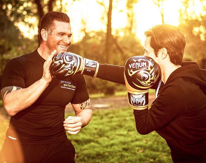 Personal Trainer beim Boxtraining im Park